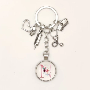 Detailed nurse keychain with syringe stethoscope and floral letter N glass pendant