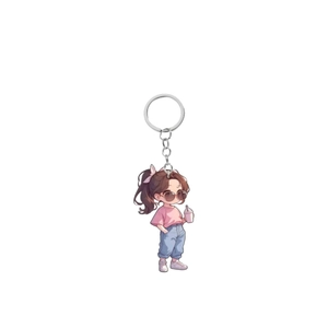 Detail of cute acrylic keychain with a cartoon girl in pink shirt and sunglasses