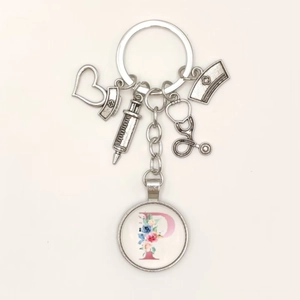 Close-up of nurse keychain with syringe stethoscope and floral letter P charms