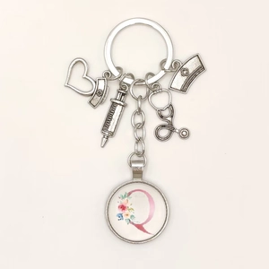 Detailed medical nurse keychain with stethoscope syringe and letter Q charm pendants