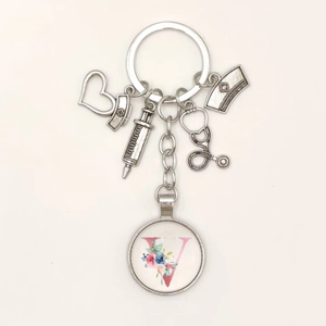 Detailed silver nurse keychain with floral pink letter V and medical charms decor