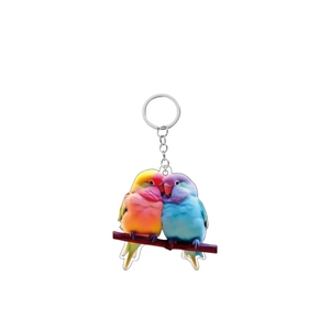 Close-up of vibrant acrylic parrot keychain showing colorful lovebirds on branch