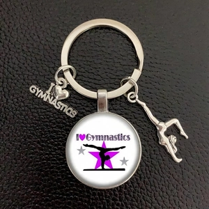Detail of silver gymnastics keychain with I Love Gymnastics glass pendant on black leather