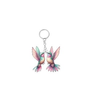 Acrylic hummingbird keychain featuring vibrant pink and purple gradients with a silver chain