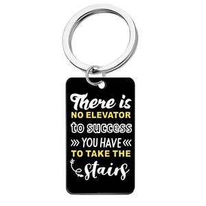 Close-up of black stainless steel keychain with white and yellow motivational quotes
