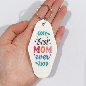 Detailed close-up of a white vintage motel keychain with Best MOM ever print