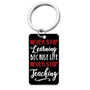 Detailed close-up of acrylic keychain with white and red inspirational quote text