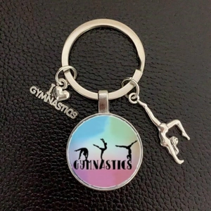 Detailed view of gymnastics keychain with I Heart Gymnastics tag and glass pendant