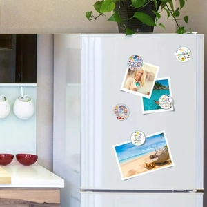 Detail view of 25mm glass magnets with rainbow patterns used to hold photos on a fridge