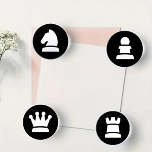 Detailed view of four round 25mm glass chess pattern magnets on a decorative card