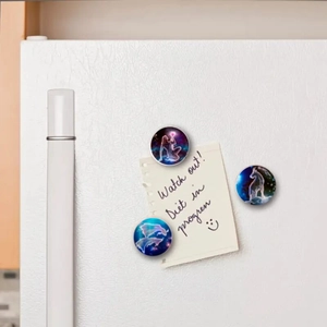 Detailed view of round constellation glass magnets on a white refrigerator surface