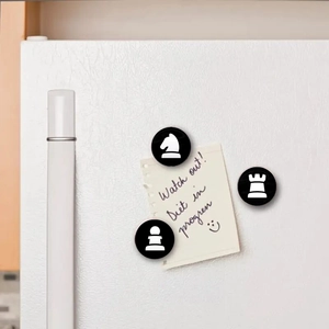 Detail of 25mm chess pattern magnets holding a yellow sticky note on a white fridge door