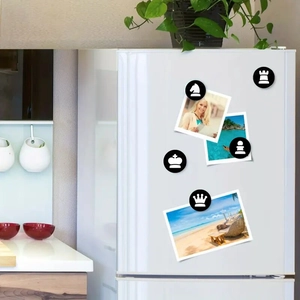 Detail of 25mm glass chess fridge magnets on a white refrigerator in a kitchen setting