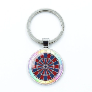 Close-up of metal dartboard keychain with red and blue target pattern and score numbers