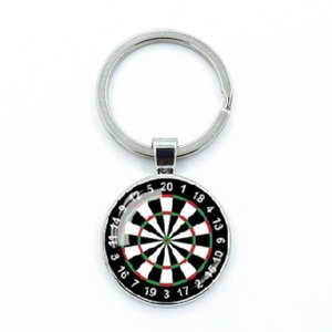 Macro detail of dartboard keychain featuring round glass dome and metal clasp