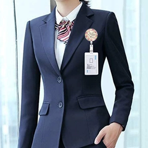 Detail of retractable badge holder with floral design and motivational quote on professional suit