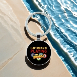 Detail of metal Bingo keychain featuring colorful ball graphics and playful text on stone