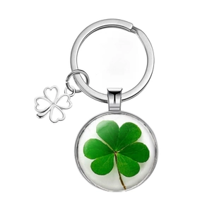 Lucky four-leaf clover keychain with silver metal ring and circular glass cabochon pendant