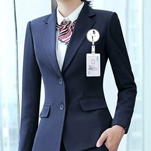 Detail of retractable badge reel with ballet dancer silhouette on a blue business suit