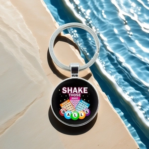 Detail of silver bingo ball keychain with colorful graphics on a summer water background