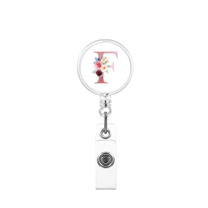 Detail showing retractable badge reel with letter F and pink floral glass dome design