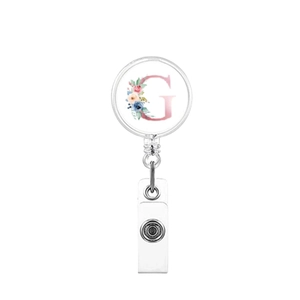 Detail of retractable badge reel with floral letter G design and white snap strap
