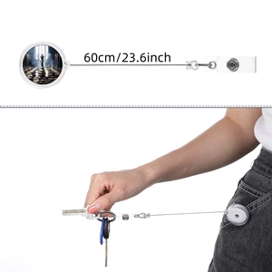 Detail showing the 60cm retractable cord of the chess themed badge reel with metal clip