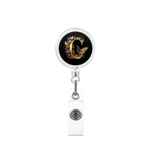 Detail of retractable ID badge reel with gold letter C and butterfly design on black base