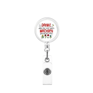 Retractable badge reel with colorful flower design and German motivational quote