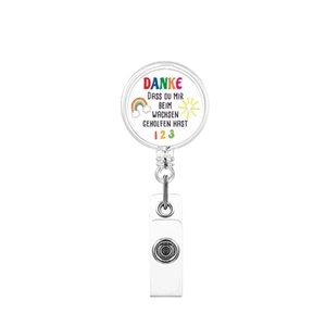 Detail view of retractable badge reel with rainbow sun design and German text