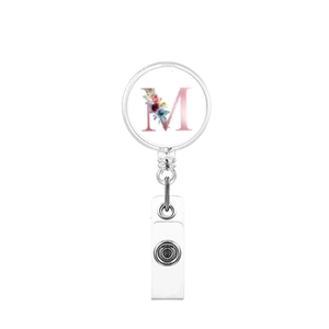 Detailed close-up of retractable badge reel featuring a floral pink letter M design