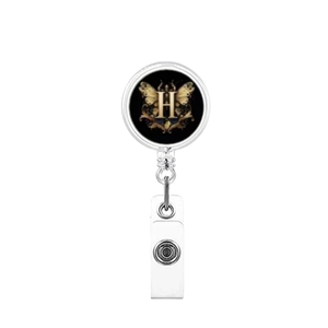 Detail of retractable badge holder with letter H and butterfly wing design on black