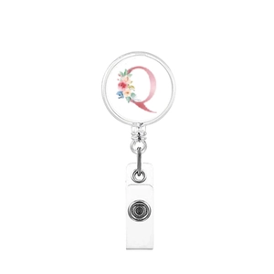 Close-up of floral letter Q retractable badge reel with a clear PVC strap and metal snap