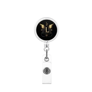 Detail of retractable badge reel with gold letter L and wings on a black background