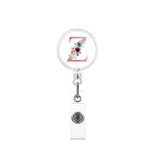 Close-up of retractable badge reel with floral letter Z design and silver metal clip