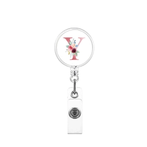 Detail of retractable badge reel with floral letter Y design and white plastic strap