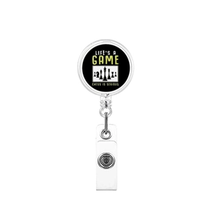 Macro detail of retractable badge reel featuring chess pattern and Life's A Game text