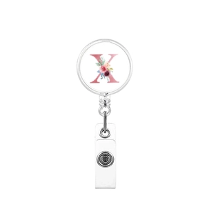 Detail of retractable badge reel featuring floral letter X print and metal clip