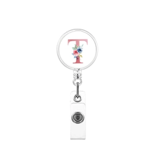 Macro shot of retractable badge holder with floral letter T design on white background