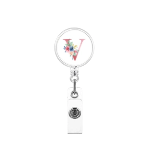 Close-up of retractable badge reel with floral letter V design and clear PVC clip