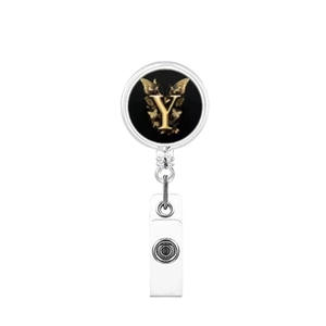 Detail of retractable badge holder featuring golden letter Y and butterfly motif on black