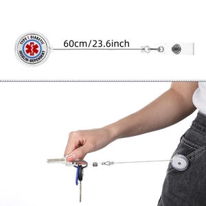Retractable badge reel detail showing medical alert logo and 60cm extension cord length