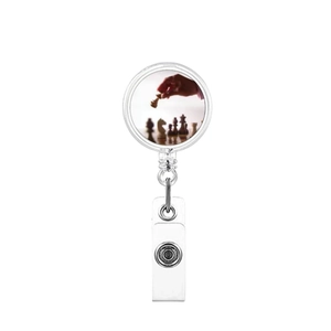 Close-up of retractable ID badge reel with chess graphic and white plastic shell