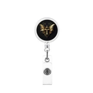 Detail of retractable badge holder with gold baroque letter T on black background