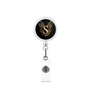 Detail of retractable badge reel with gold letter S and vintage floral accents
