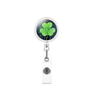 Detail view of retractable badge holder with green clover print and durable metal clip