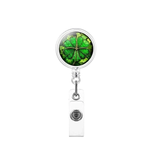 Detail view of lucky green clover badge reel with retractable silver metal frame and clip
