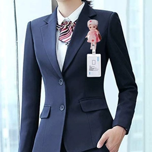Detail of retractable ID badge holder with cute nurse figurine on blue uniform