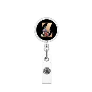 Detail of retractable badge holder with black floral pattern and golden letter Z print