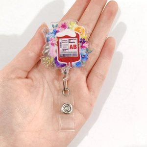 Detail of retractable badge reel with blood bag and floral acrylic print for healthcare